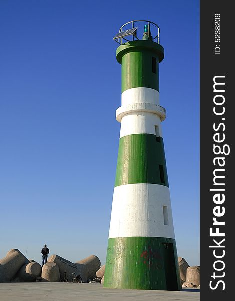 Green lighthouse with blue sky