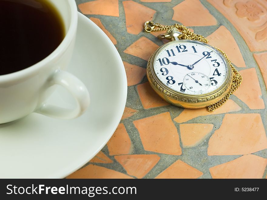 Watching time pass on a vintage pocket watch,  during a coffee break. Watching time pass on a vintage pocket watch,  during a coffee break