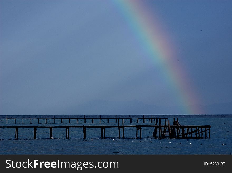 After a brief shower, a colorfull rainbow
surfaced and break the sky into two partition