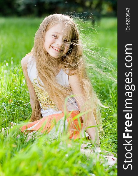 Little girl in perfect green grass, focus on face