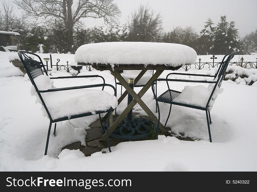 Garden table & chairs covered in deep snow. Garden table & chairs covered in deep snow