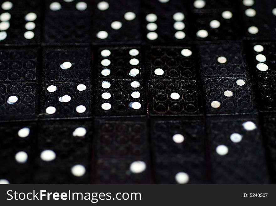 A photograph of rows of domino tiles with splodgy pips on display. A photograph of rows of domino tiles with splodgy pips on display