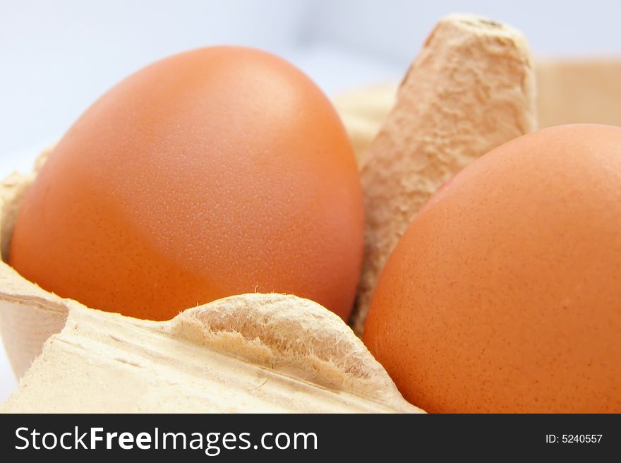 Fresh healthy brown eggs in a cardboard egg holder. Fresh healthy brown eggs in a cardboard egg holder