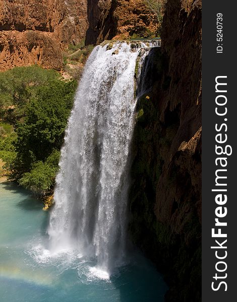 The stunning Havasu waterfall carves its way through the canyon's landscape offering a refreshing oasis from the desert's heat.