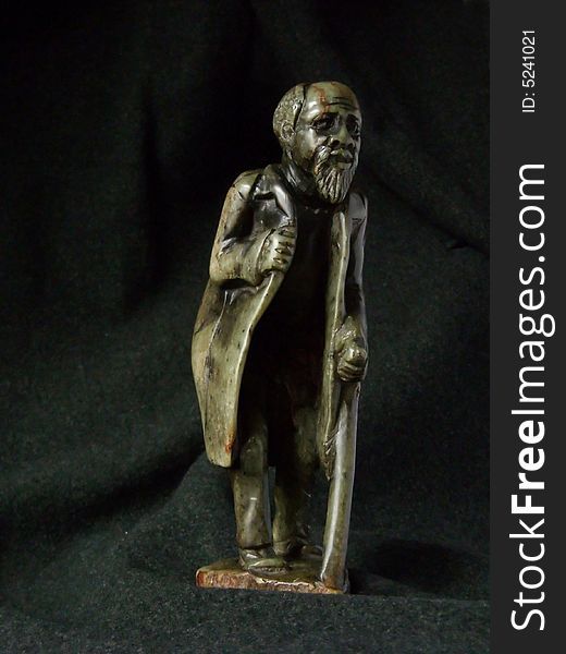 Verdite sculpture of old African man with a cane. Verdite sculpture of old African man with a cane.