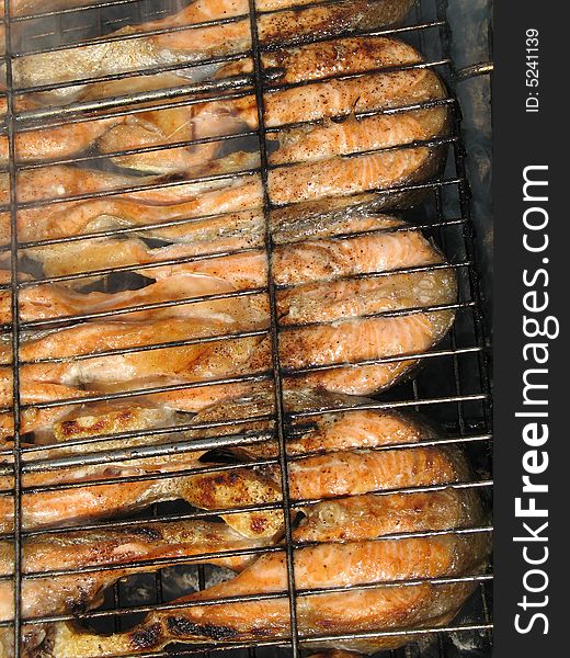 Close-up of the grilled salmon pieces (background)