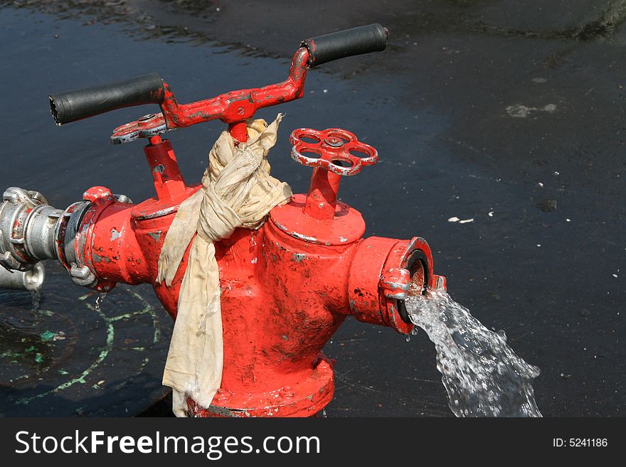 Red fire hydrant with flowing water