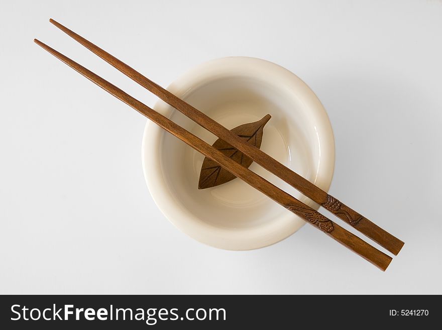 Chopsticks in a bowl with wooden leaf - with clipping path. Chopsticks in a bowl with wooden leaf - with clipping path