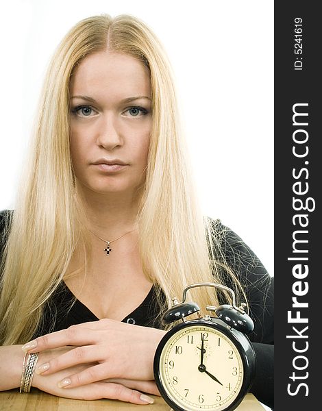 Young blond woman with clock