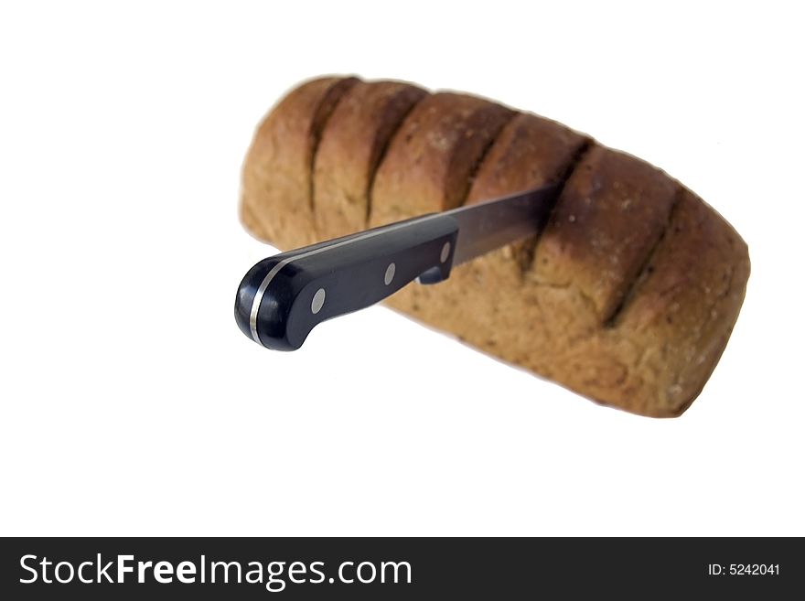 Bread loaf with knife isolated on white. Bread loaf with knife isolated on white