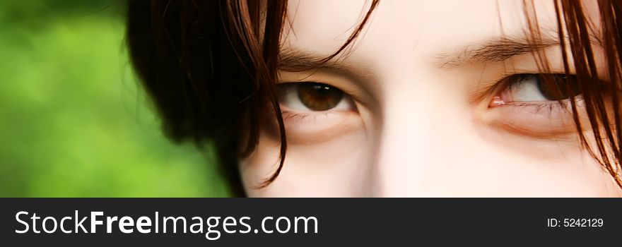 A gaze of beautiful young woman with brown eyes and hair