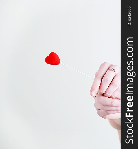 Red lovely heart in woman hands at white background. Red lovely heart in woman hands at white background