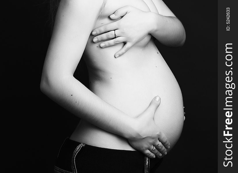 Pregnant young beauty woman at black background. Pregnant young beauty woman at black background