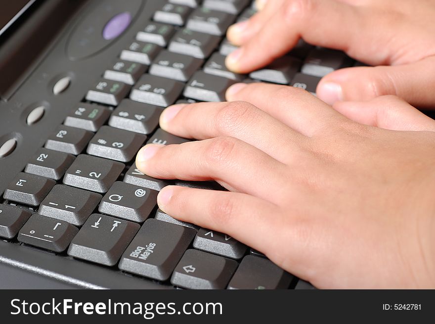 Hands of a kid on a laptop keyboard. Hands of a kid on a laptop keyboard