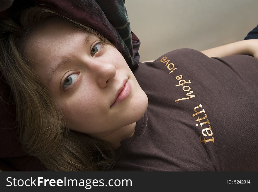 Picture of a beautiful woman lying down giving off a smile. Picture of a beautiful woman lying down giving off a smile