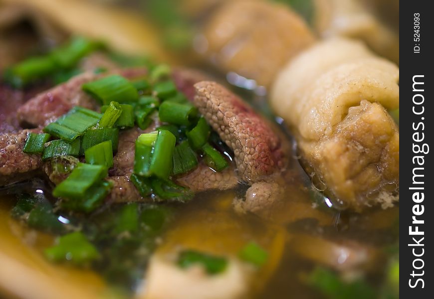 Asian dish of a tea flavored herbal clear  soup of  pork ribs, liver and stomach, served hot and sprinkled with chopped spring onions. Asian dish of a tea flavored herbal clear  soup of  pork ribs, liver and stomach, served hot and sprinkled with chopped spring onions.