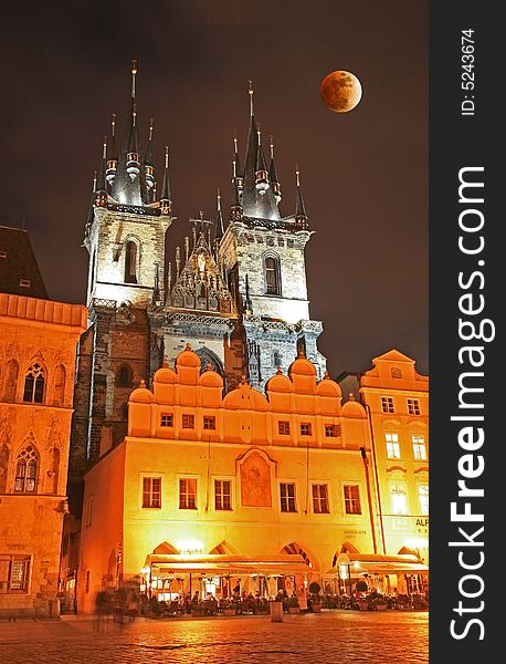 The old town square in Prague and moon eclipse