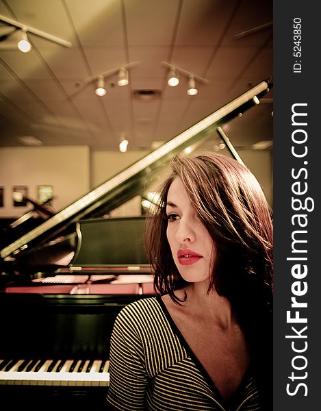 Young female model in a piano store.