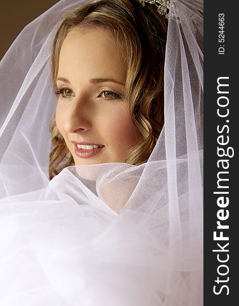 A bride sitting infront of a window. A bride sitting infront of a window