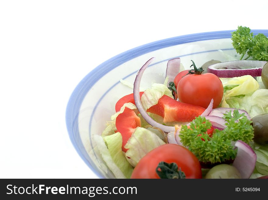 Italian salad in a bowl, against a white background. Italian salad in a bowl, against a white background