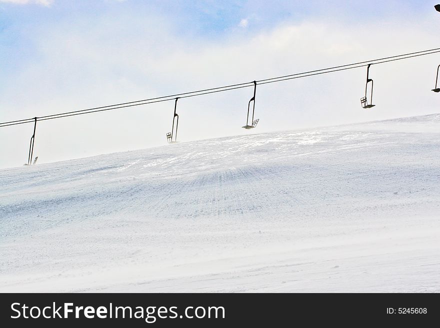 Ski chair lifts sit unused and frozen. Ski chair lifts sit unused and frozen