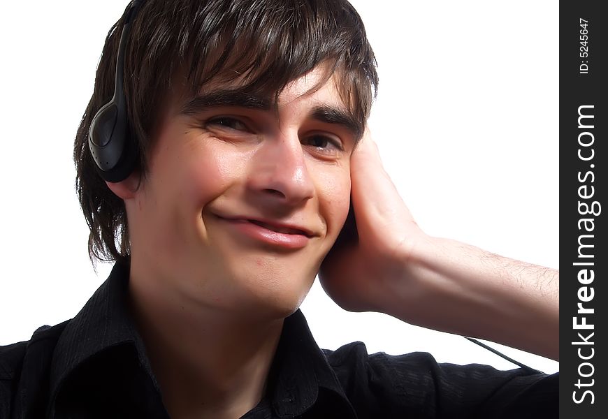 A portrait about a trendy attractive young guy who is smiling, he is listening to music and he has a charming look. He is wearing a stylish black shirt. A portrait about a trendy attractive young guy who is smiling, he is listening to music and he has a charming look. He is wearing a stylish black shirt.