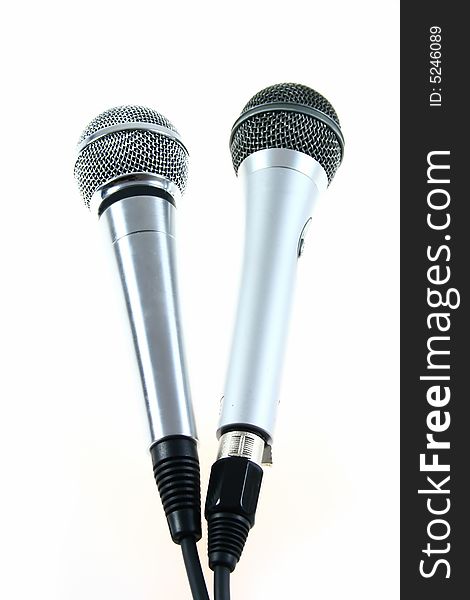 Two different microphones on white background