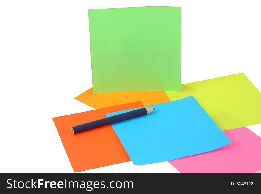 Colored papers and pen isolated on white background