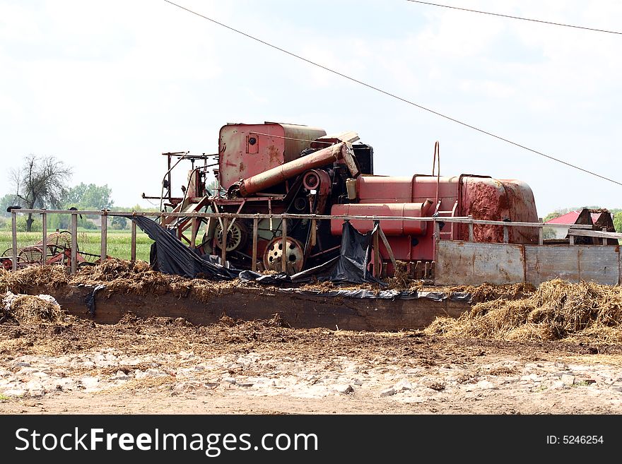 Village scene - very old harvest machine