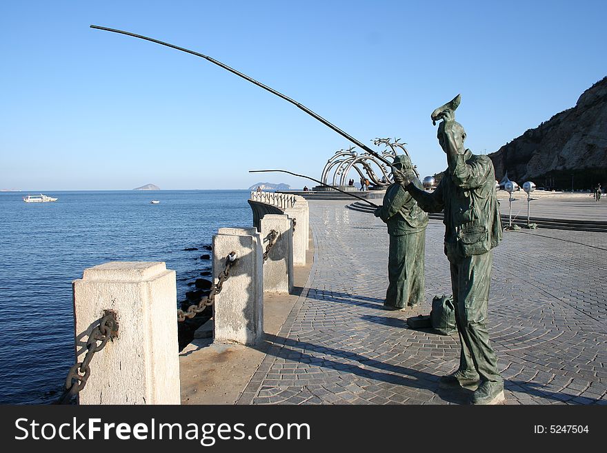 Sculptures of fishing men on the coast. Sculptures of fishing men on the coast