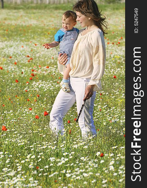 Mother and son walking through flowers