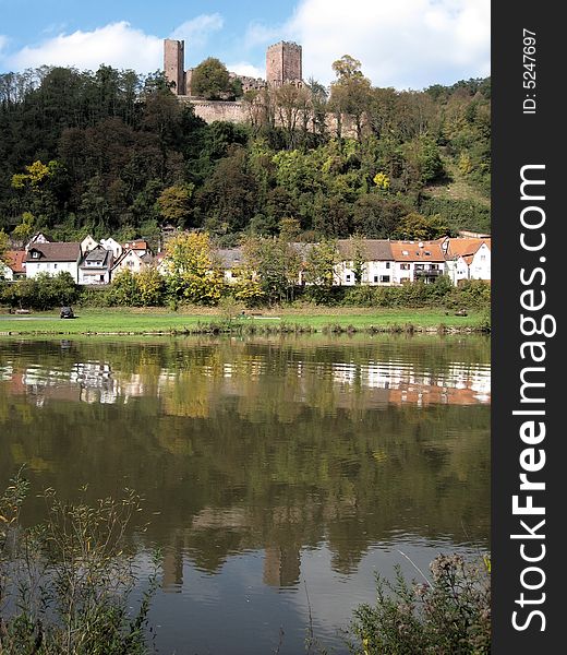 Village and castle ruin reflected in the river Main near Miltenburg, Germany. Village and castle ruin reflected in the river Main near Miltenburg, Germany.