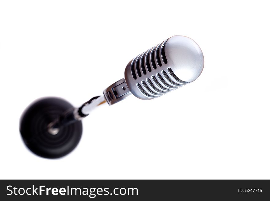 A vintage looking microphone on a white background with copy space. A vintage looking microphone on a white background with copy space