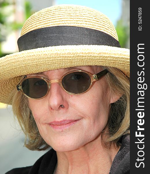 Woman from the south wearing sunglasses and a straw hat. Woman from the south wearing sunglasses and a straw hat.