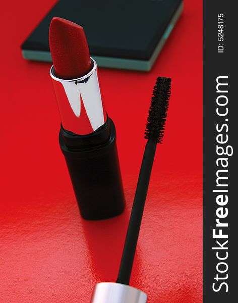 Closeup of lipstick and mascara brush. Closeup of lipstick and mascara brush