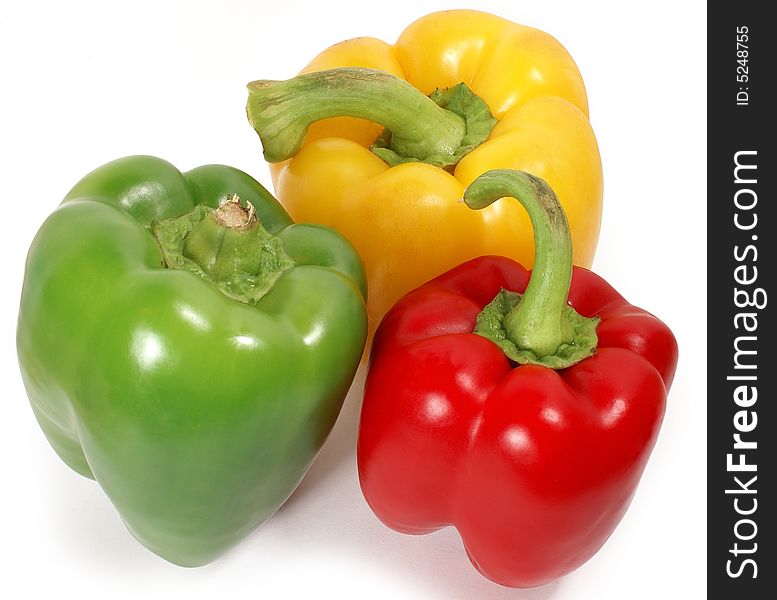 Isolated big green, red and yellow paprikas against white. Isolated big green, red and yellow paprikas against white