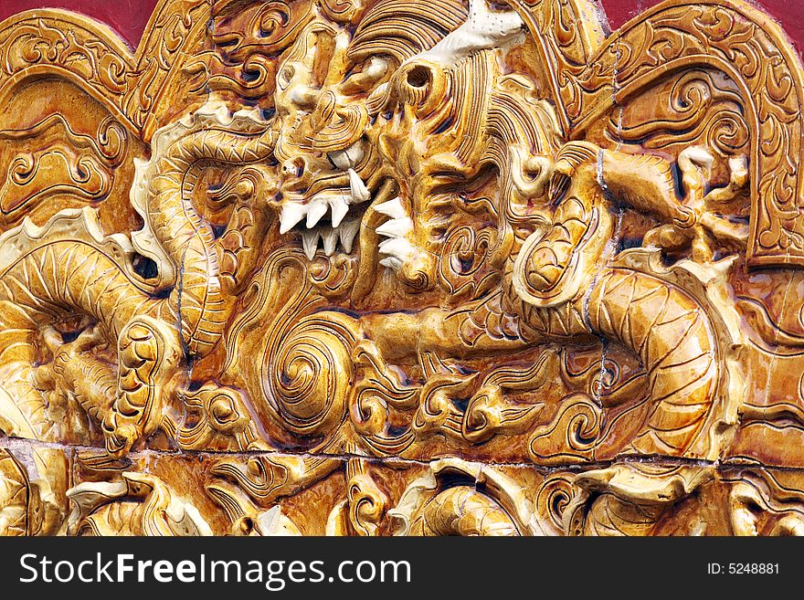 Stone carving in millennium. It is carved with the pattern of the dragon on the stone carving.