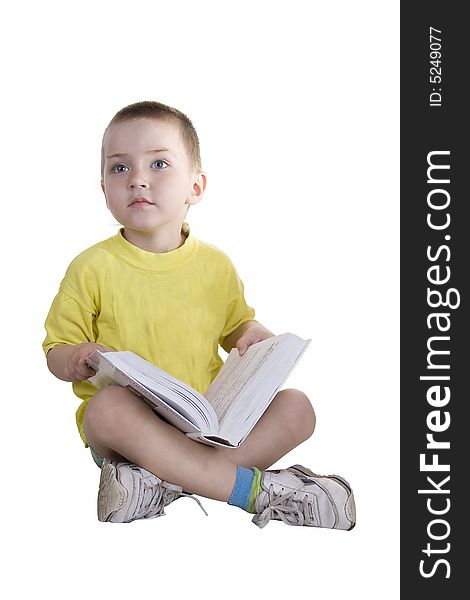 The boy reads the book on a white background. The boy reads the book on a white background