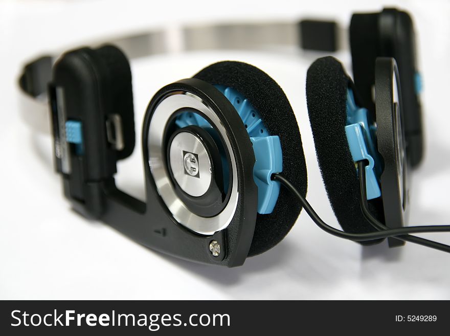 Modern headphones with blue on white background