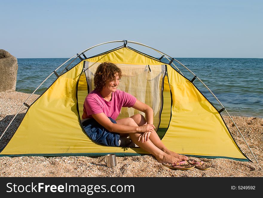 Smyling Girl Sitting In The Tent At Sea Coast