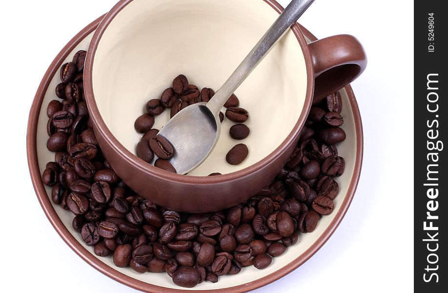 Cup and coffee beans from above and spoon. Cup and coffee beans from above and spoon