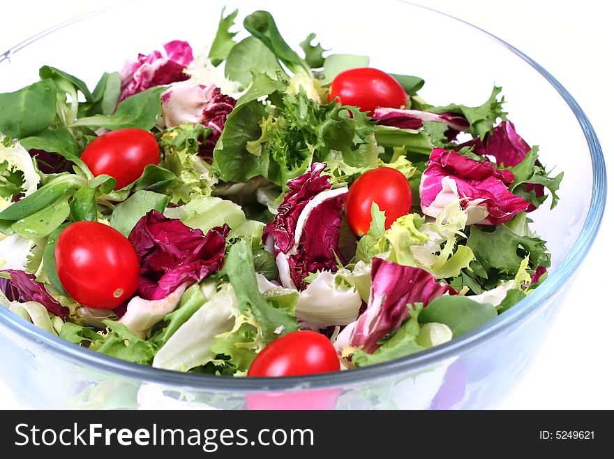 Fresh salad mix in round bowl isolated