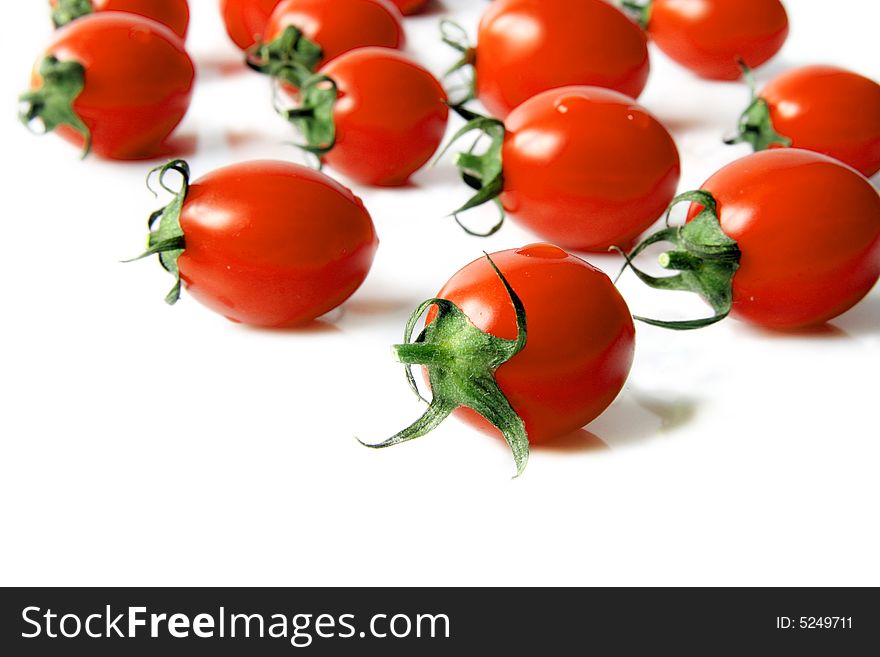 Red cherry tomatoes on a  light background