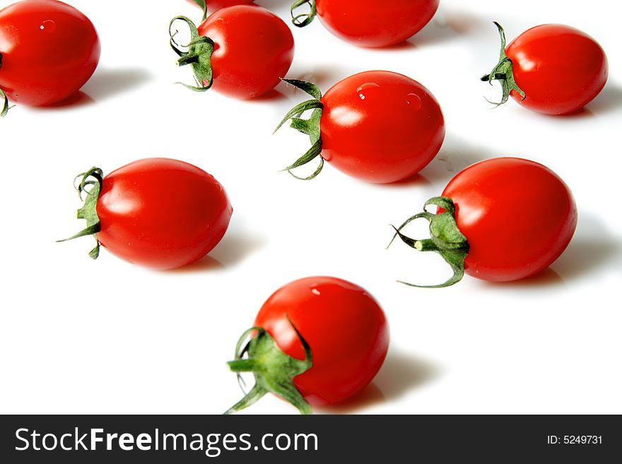 Red cherry tomatoes on a  light background