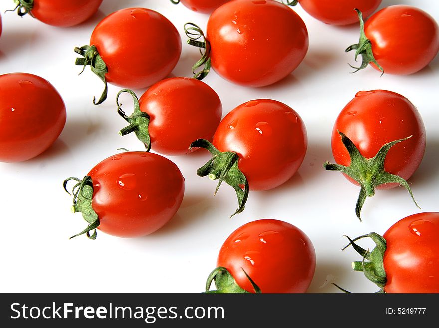 Red cherry tomatoes on a light background