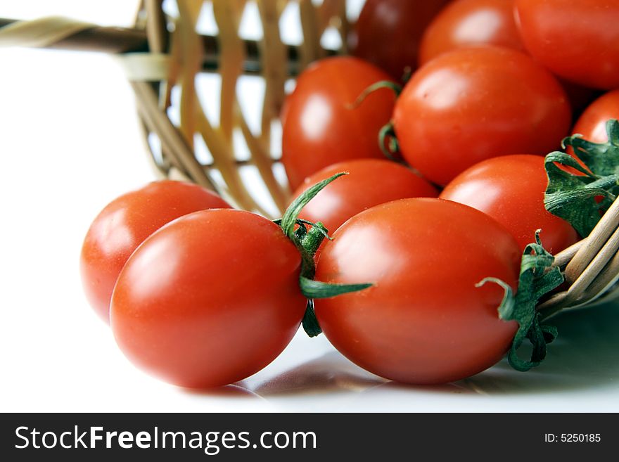 Red cherry tomatoes on a wicker basket