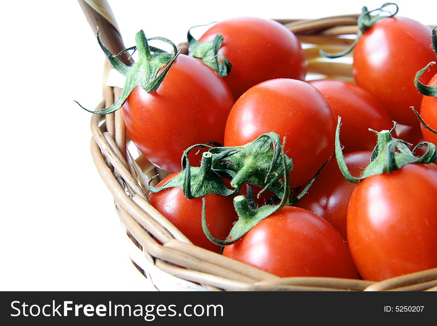 Red cherry tomatoes on a  wicker basket