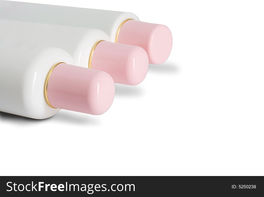 Three laying cosmetic bottles on white background with copy space
