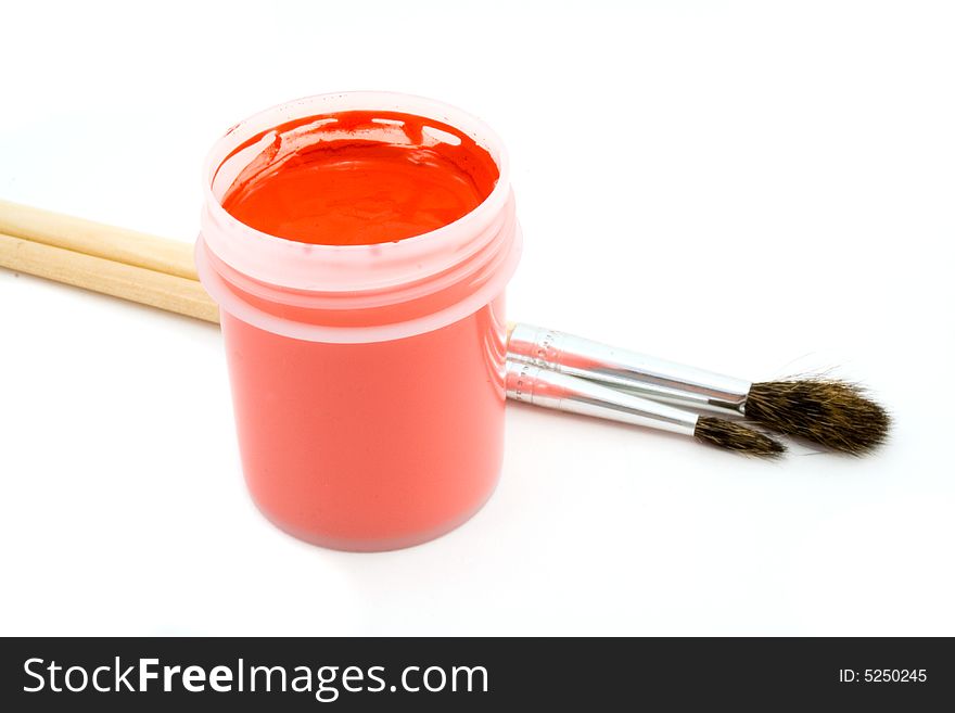 Red gouache and paintbrush isolated on white