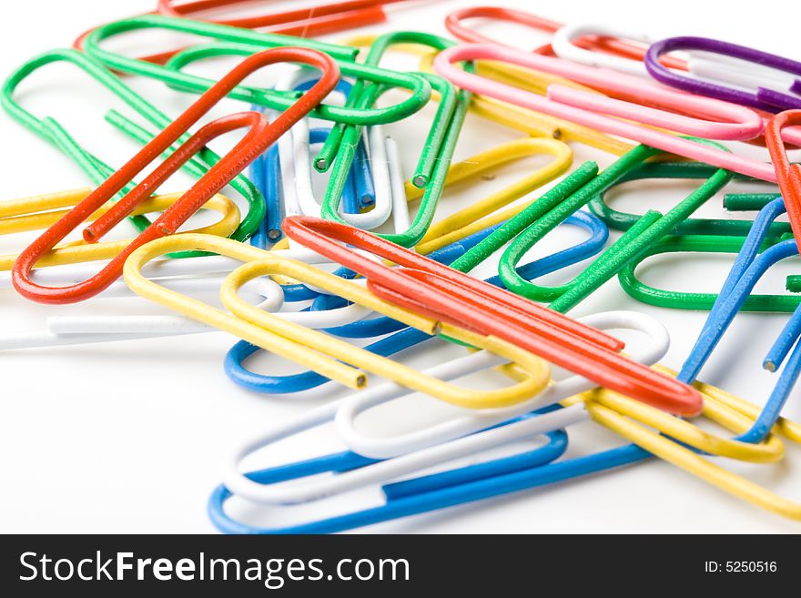 Colorful paper clips on a white background. Close up. Selective focus.